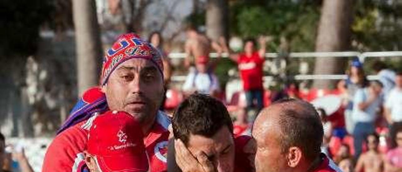 Antonio es consolado por tres seguidores tras la eliminación del Ourense en Caravaca, en 2009. // Área 11