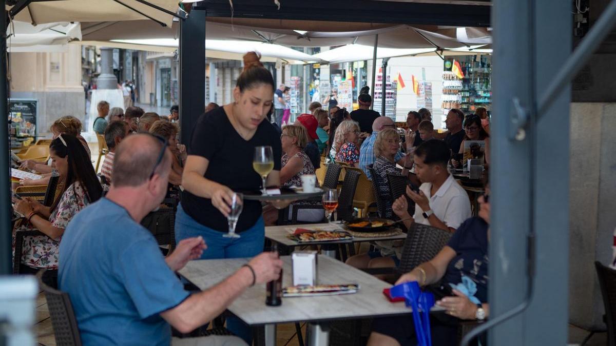 Una camarera atiende a los clientes de una terraza del centro de Cartagena.
