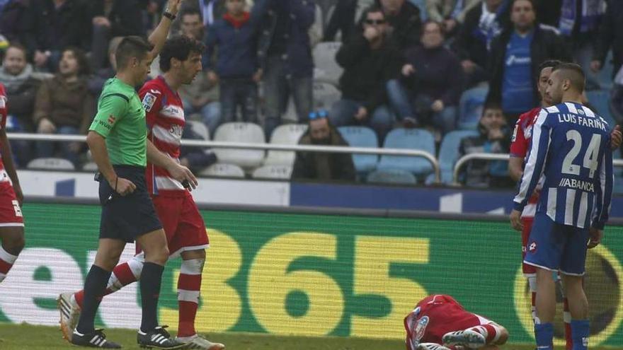 Fariña mira a Rico, en el suelo, mientras el árbitro le enseña la tarjeta roja. 13fotos