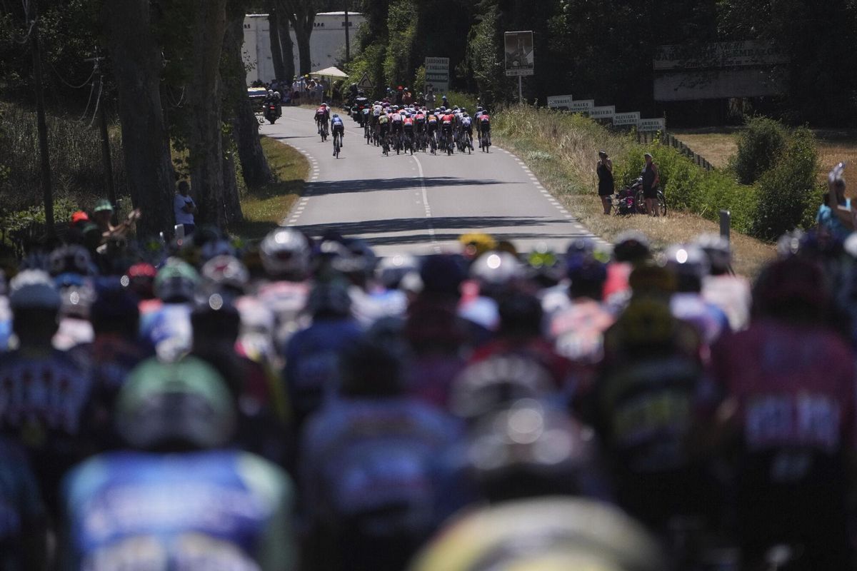 The pack watches a large group of about 50 riders break away during the twelfth stage of the Tour de France cycling race over 180.6 kilometers (112.2 miles) with start in Auch and finish in Hautacam, France, Thursday, July 17, 2025. (AP Photo/Thibault Camus)