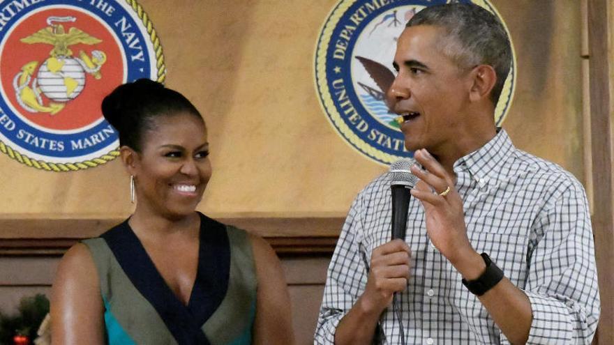 Obama, durante un discurso en Navidad junto a su esposa.