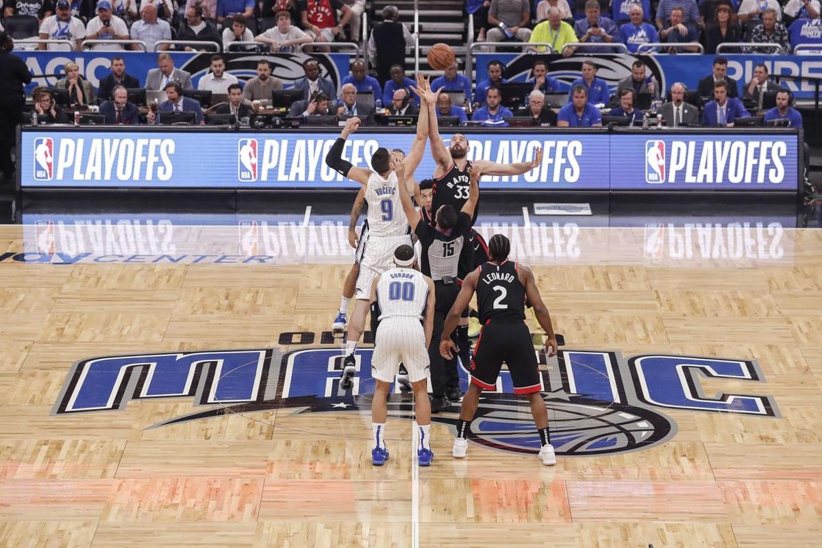 ORLANDO, FL - APRIL 21: Nikola Vucevic #9 of the Orlando Magic goes up against Marc Gasol #33 of the Toronto Raptors on the opening tip off at the start of Game Four of the first round of the 2019 NBA Eastern Conference Playoffs at the Amway Center on April 21, 2019 in Orlando, Florida. The Raptors defeated the Magic 107-85. NOTE TO USER: User expressly acknowledges and agrees that, by downloading and or using this photograph, User is consenting to the terms and conditions of the Getty Images License Agreement.   Don Juan Moore/Getty Images/AFP