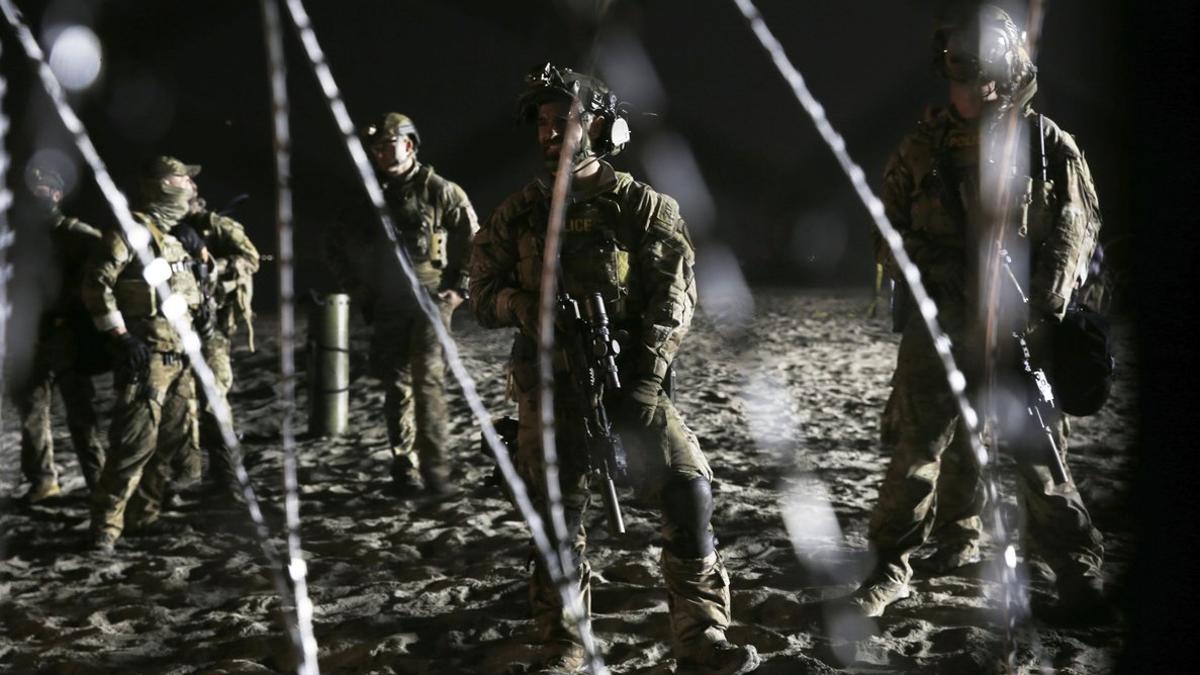 Agentes de la patrulla de fronteras de EEUU, junto a la valla que les separa de Tijuana.