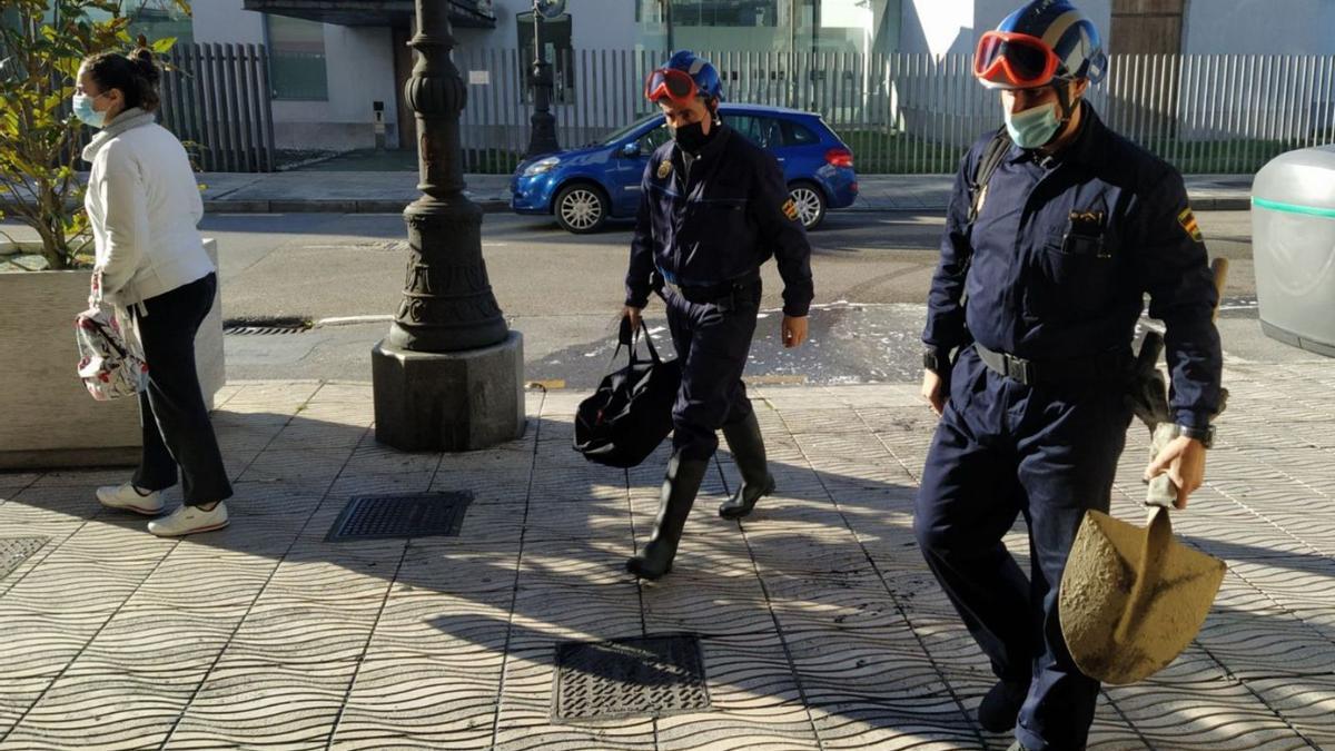 Los agentes, antes de entrar en el edificio. | M. Á. G.