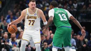 Los Angeles Lakers guard Luka Doncic (77) works the floor against Dallas Mavericks forward Naji Marshall (13) during the first half of an NBA basketball game Saturday, Jan. 24, 2026, in Dallas. (AP Photo/Julio Cortez)