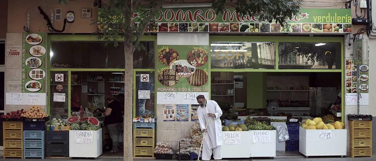 Carteles llamativos en el exterior de una frutería de barrio.