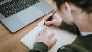 Una estudiante, en una biblioteca para repasar un examen.