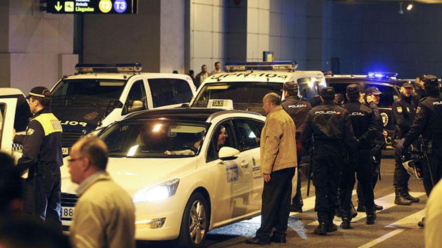 Los taxistas se concentraron ayer en el aeropuerto bajo una fuerte vigilancia policial.