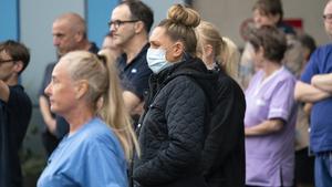 SALFORD,  UNITED KINGDOM- APRIL 28: NHS staff take part in a minute’s silence outside Salford Royal Hospital on April 28, 2020 in Salford, United Kingdom. The moment of silence, commemorating the key workers who have died during the Covid-19 pandemic, was timed to coincide with International Workers’ Memorial Day. At least 90 NHS workers are reported to have died in the last month, in addition to transport employees and other key workers. (Photo by Christopher Furlong/Getty Images)