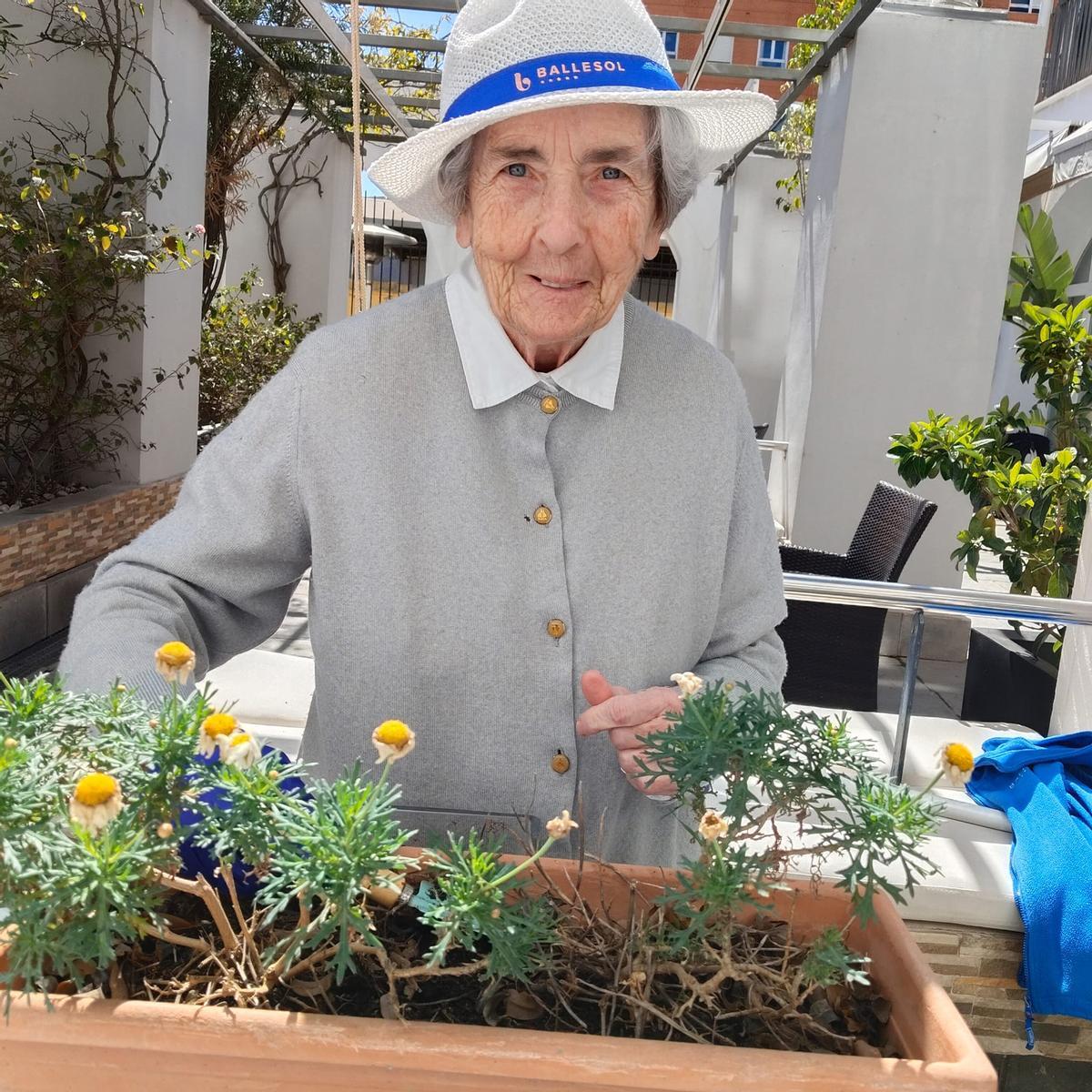 Una mujer realiza ejercicios de jardinería en una residencia Ballesol.