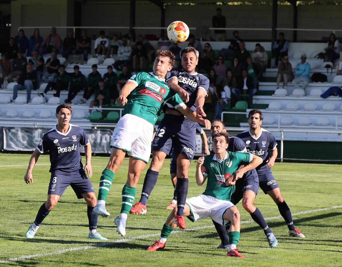 Dos jugadores tratan de alcanzar el balón de cabeza.