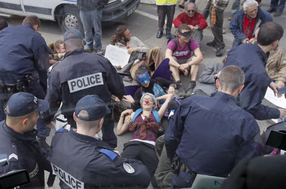 La policia francesa desallotja diversos manifestants al carrer, que bloquegen un autobús de la premsa per protestar contra la construcció del futur estadi de futbol de l’Olympique Lió, a Meyzieu.