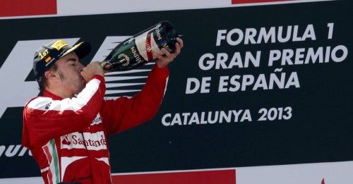 Ferrari Formula One driver Alonso of Spain drinks champagne on the podium after winning the Spanish F1 Grand Prix in Montmelo