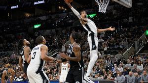 San Antonio Spurs center Victor Wembanyama (1) goes up to dunk during the second half of an NBA basketball game against the Brooklyn Nets, Sunday, Oct. 26, 2025, in San Antonio. (AP Photo/Darren Abate)