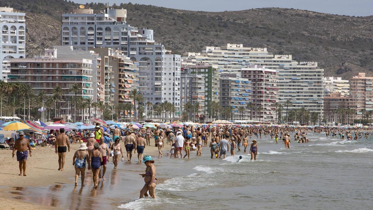Centenares de vecinos se bañan o toman el sol en la playa de Cullera, en una imagen de archivo.