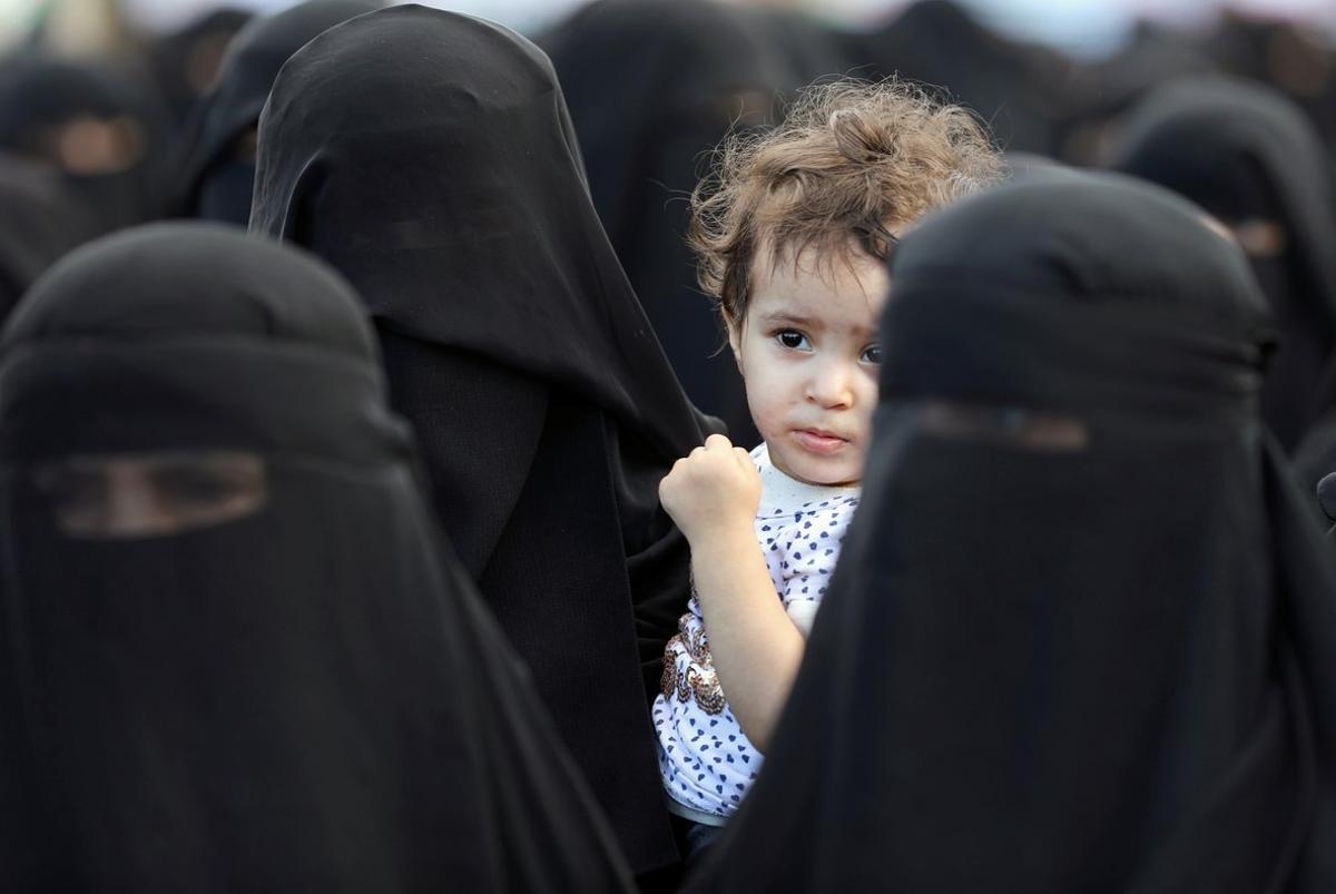 A boy looks as he and women supporters of the Houthi movement attend a rally held to celebrate following claims of military advances by the group near the borders with Saudi Arabia, in Sanaa, Yemen October 1, 2019. REUTERS/Khaled Abdullah