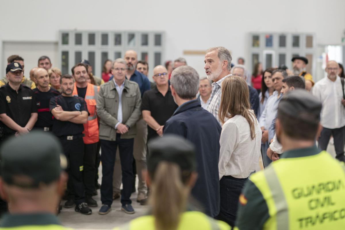 El rey Felipe conversa con un grupo de representantes de los medios de extinción de incendios que han participado en las labores en la zona mientras visitan el Centro de Coordinación del Distrito Forestal XIV de Verín (Ourense)
