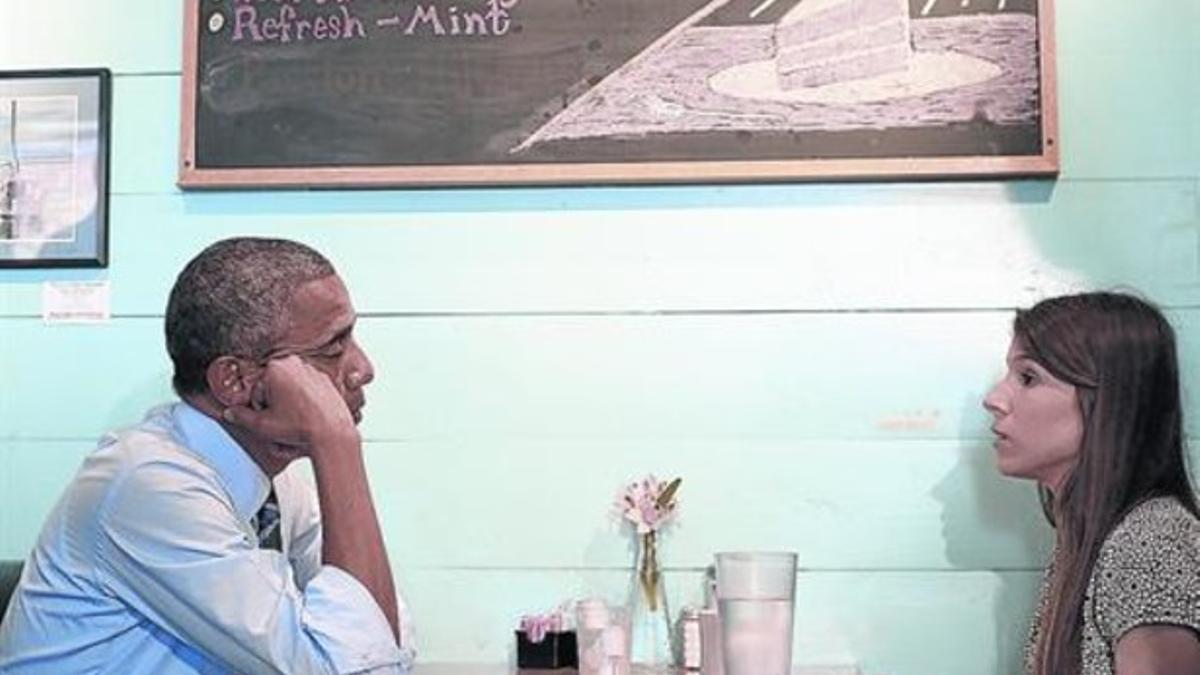Obama escucha las inquietudes de una estudiante en un restaurante de Austin, ayer.
