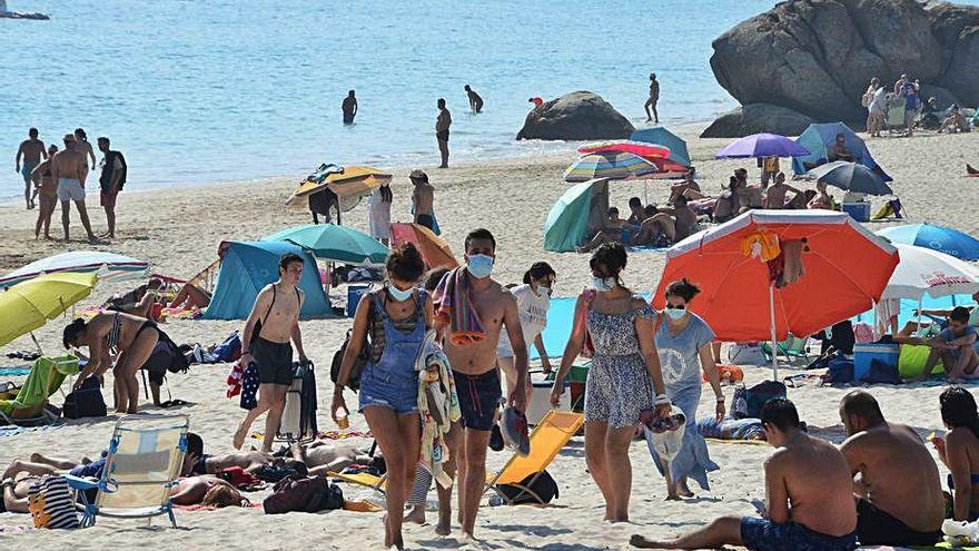 Bañistas con mascarillas en Nerga.