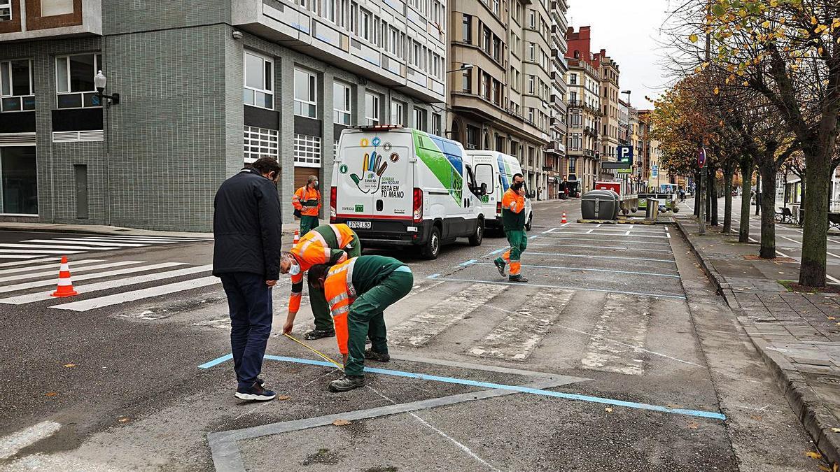 Operarios de Emulsa trabajan en la señalización de la nueva zona de aparcamiento en la calle de Rodríguez San Pedro. | Juan Plaza