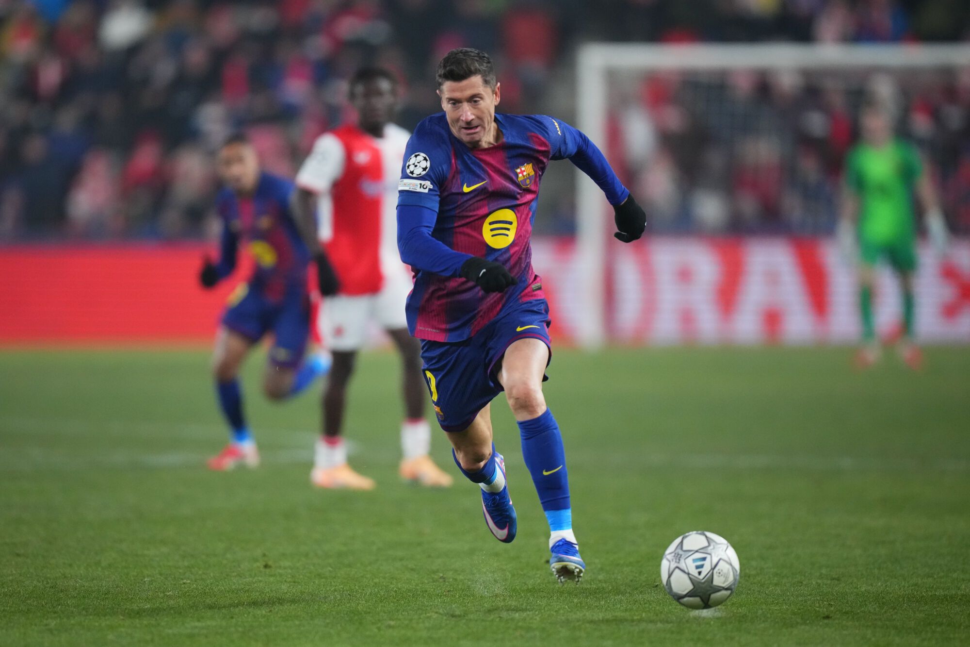 Barcelona's Robert Lewandowski runs with the ball during the Champions League opening phase soccer match between Slavia Prague and Barcelona in Prague, Czech Republic, Wednesday, Jan. 21, 2026. (AP Photo/Petr David Josek)