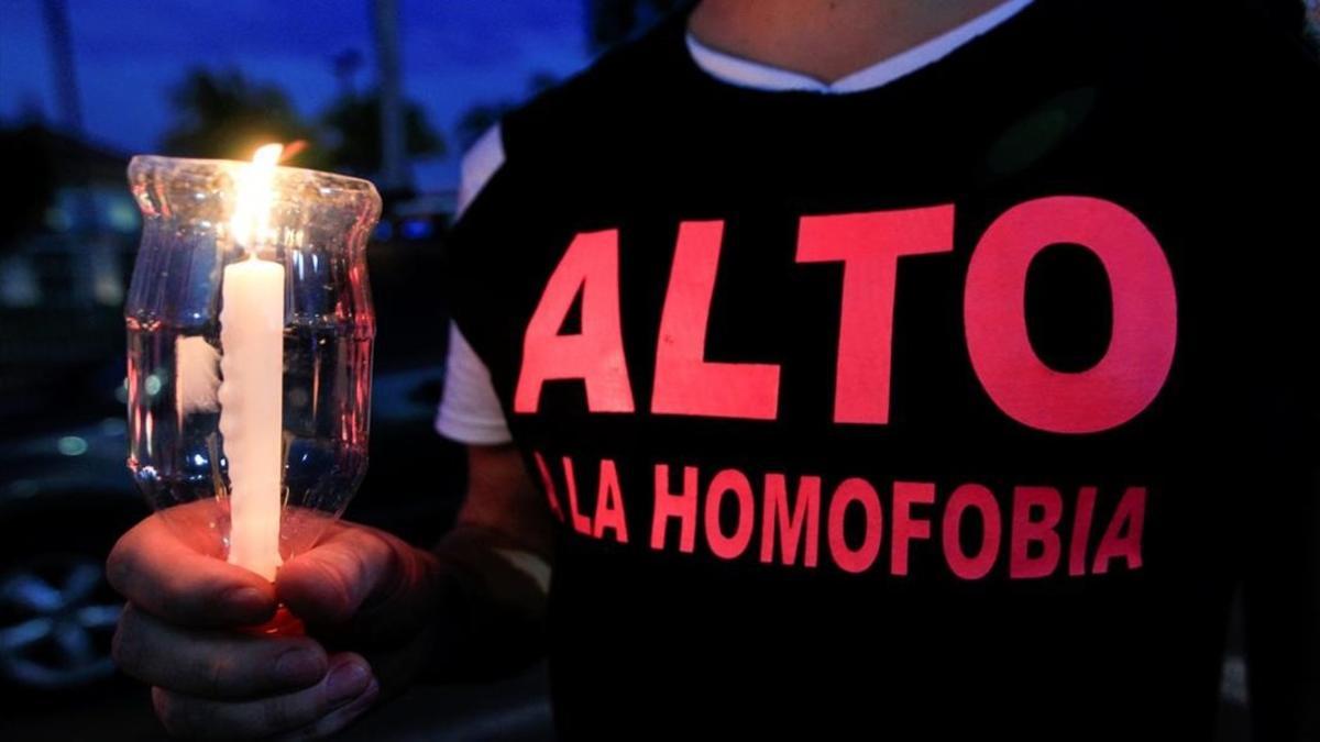 Un activista por los derechos de los homosexuales sostiene una vela encendida en recuerdo de las víctimas de Orlando.
