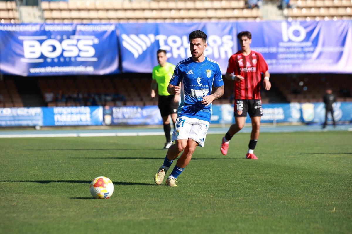 El local Zeki Díaz realiza un pase ante la vigilancia del rojillo Capi, en Chapín.