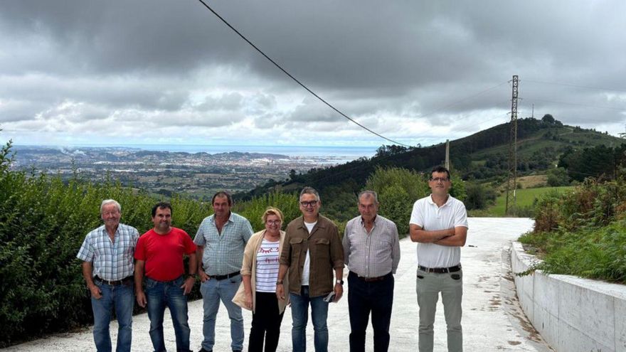 Gilberto Villoria y José Antonio Piñera, junto a los vecinos de la zona, en el Camín de la Cruz, ayer. |