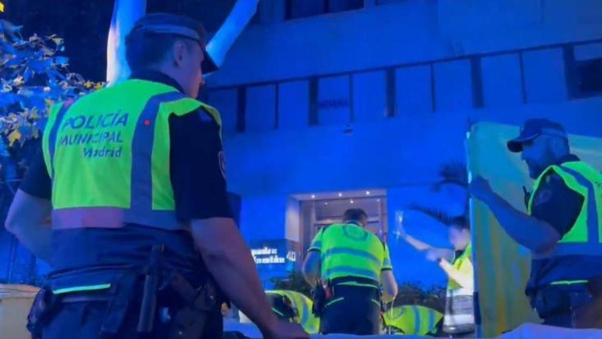 Policías municipales y miembros del servicio de emergencias de Madrid atendiendo a la víctima.
