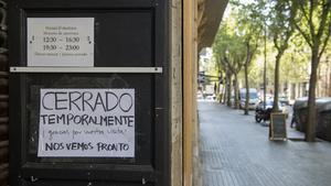 Cartel informando del cierre temporal de un restaurante por la crisis del coronavirus, en Barcelona el 3 de abril.