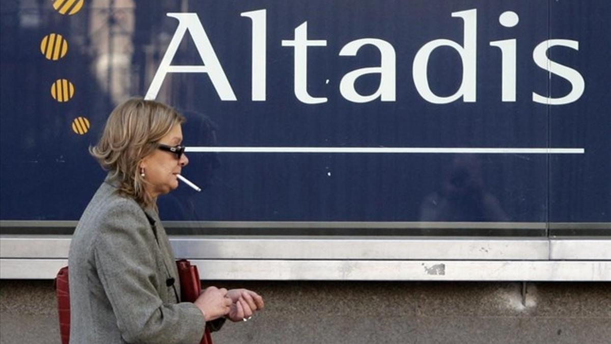 Una mujer camina ante las oficinas de Altadis en Madrid.