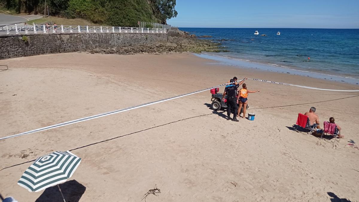 Agentes de la Policía Local, en la zona acordonada de la playa riosellana. | J. Q.