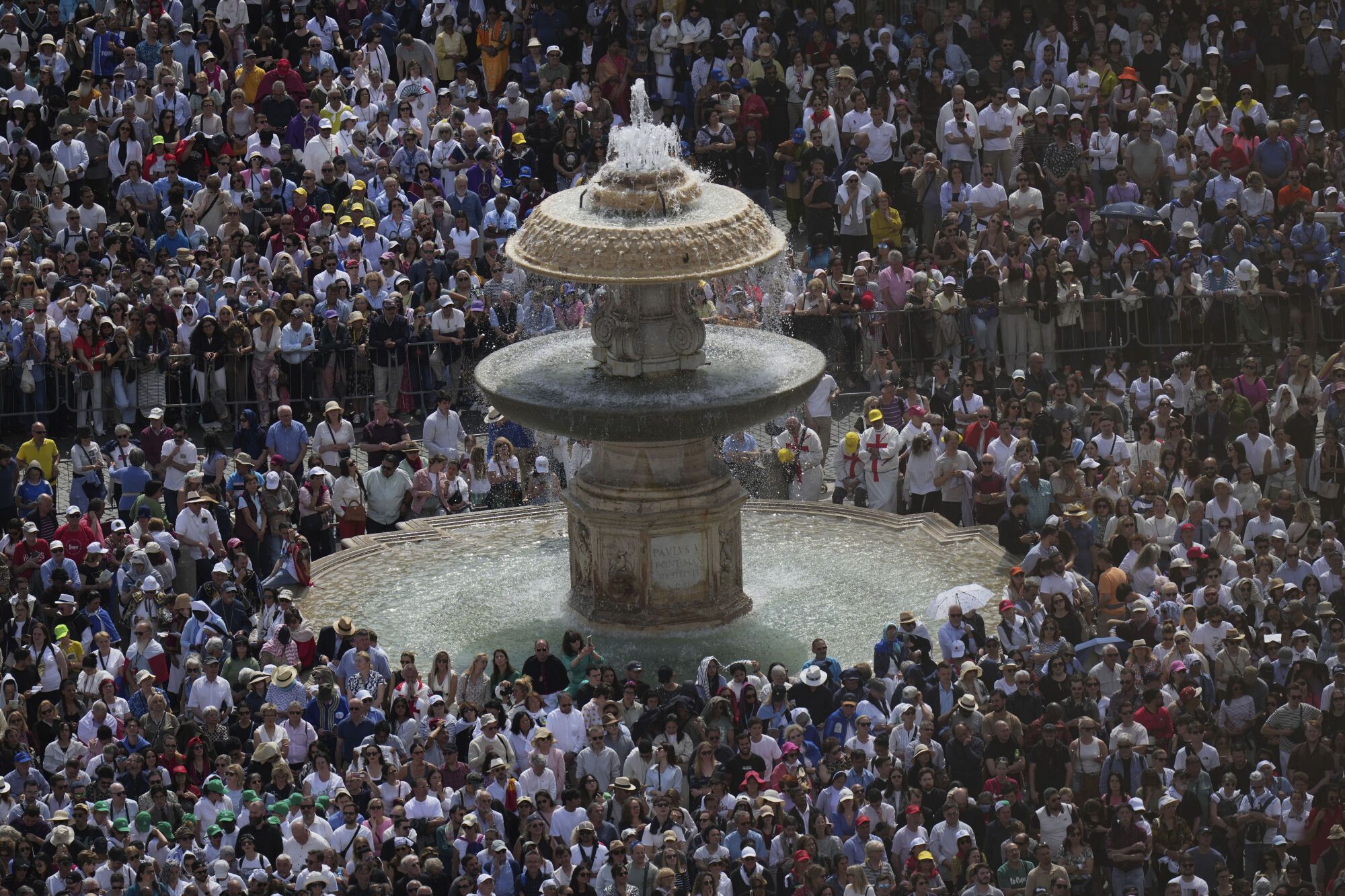 People gather as Pope Leo XIV celebrates a Mass for the formal inauguration of his pontificate, in St. Peter's Square, at the Vatican, Sunday, May 18, 2025. (AP Photo/Alessandra Tarantino)