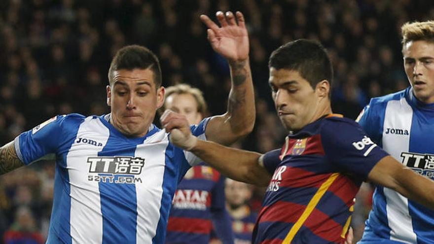 Roco lucha por un balón con Luis Suárez en un Barça-Espanyol.