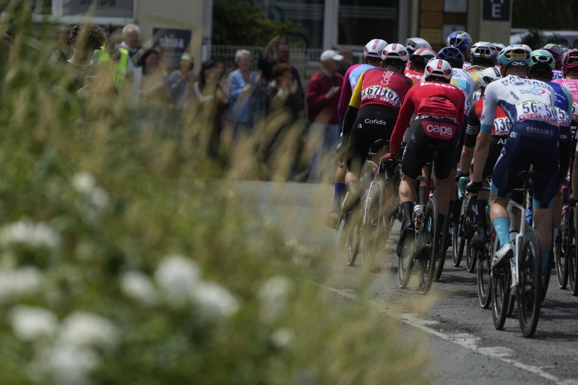 The pack rides during the third stage of the Tour de France cycling race over 178.3 kilometers (110.8 miles) with start in Valenciennes and finish in Dunkerque, France, Monday, July 7, 2025. (AP Photo/Mosa'ab Elshamy)