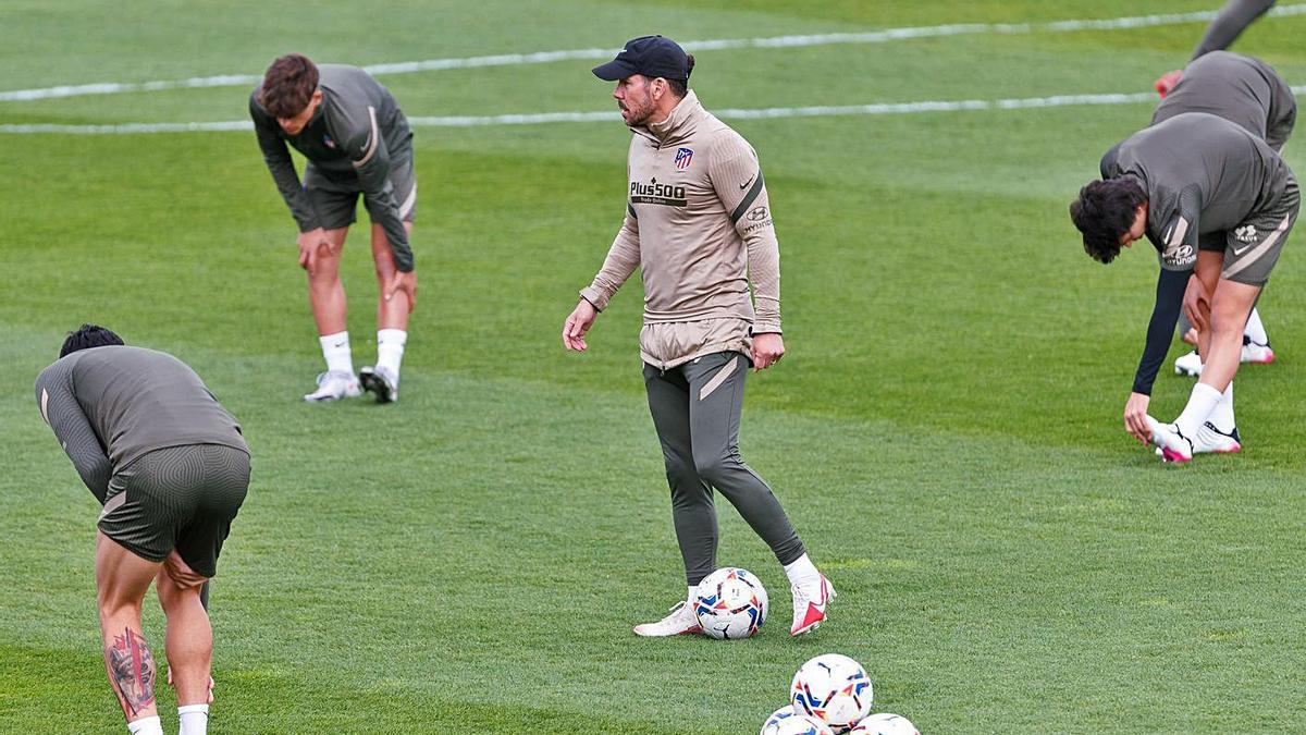 Simeone, rodeado de sus jugadores en el entrenamiento de ayer. |  // E. P.