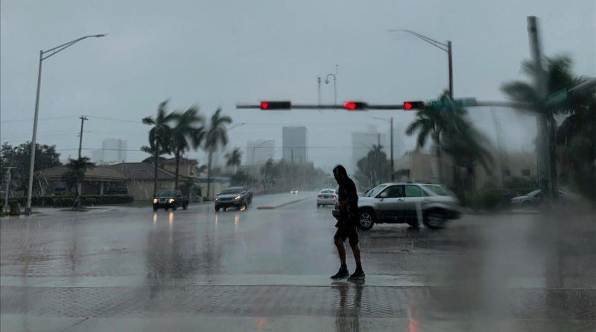 undefined49686425 topshot   a man crosses the street during a pouring rain in 190903180258