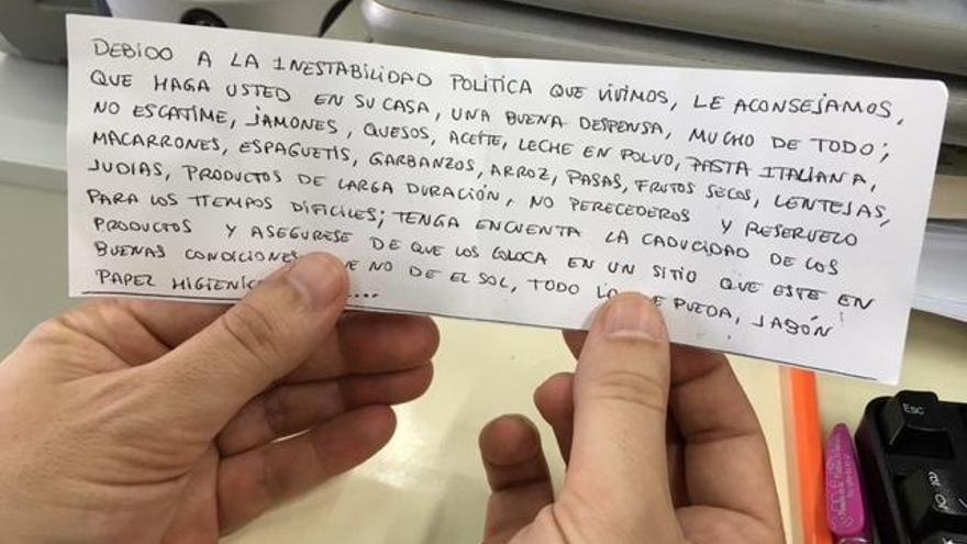 Una persona sostiene el papel con las manos