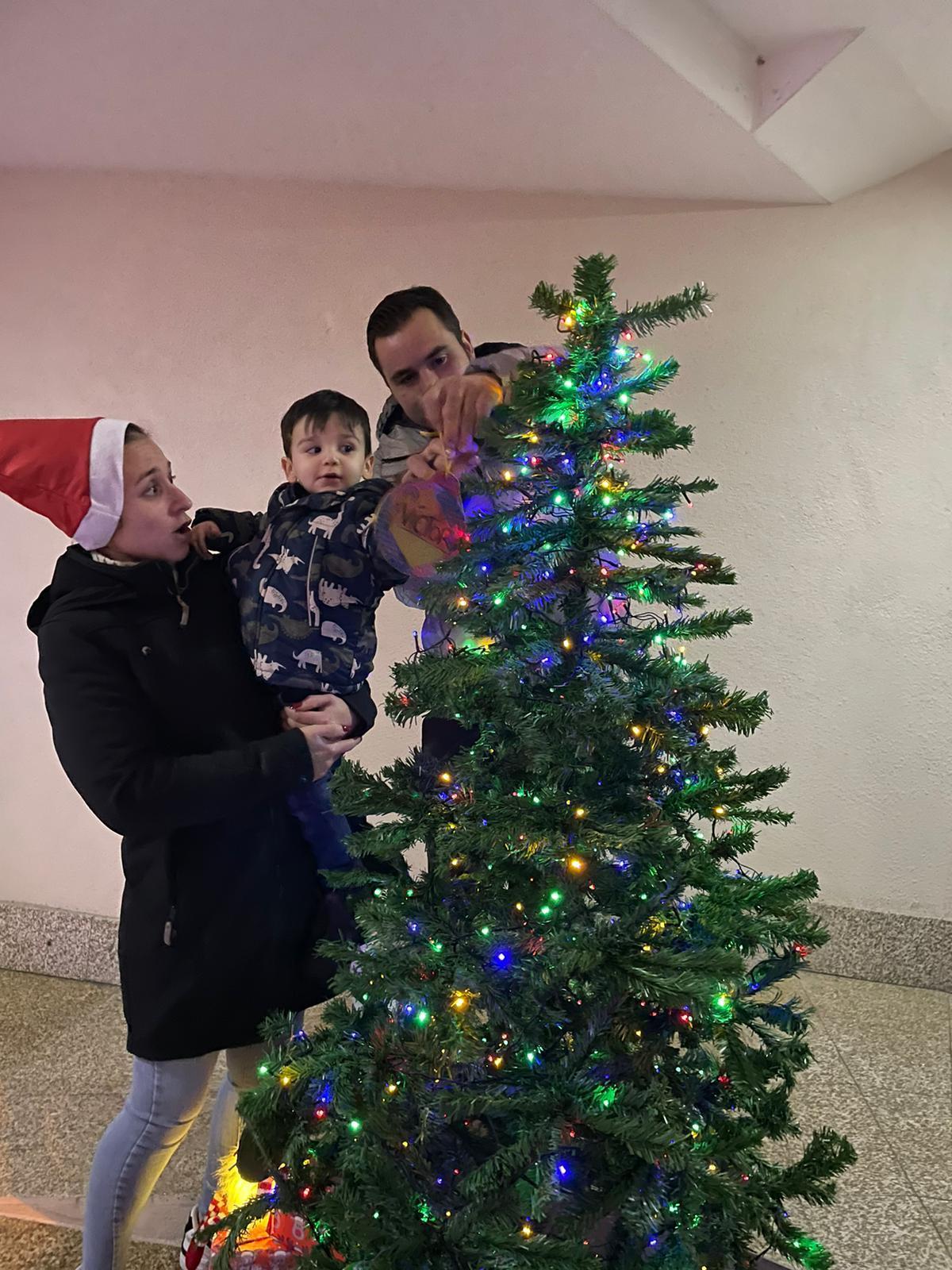 Una de las familias del edificio junto al árbol de navidad.