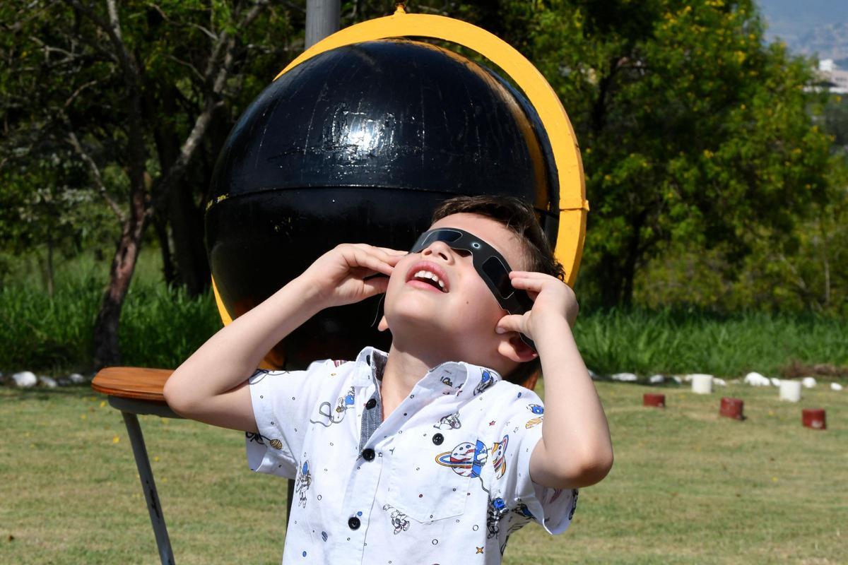 Un niño prueba sus gafas para divisar el eclipse anular en el Observatorio Nacional de la Universidad de Honduras.