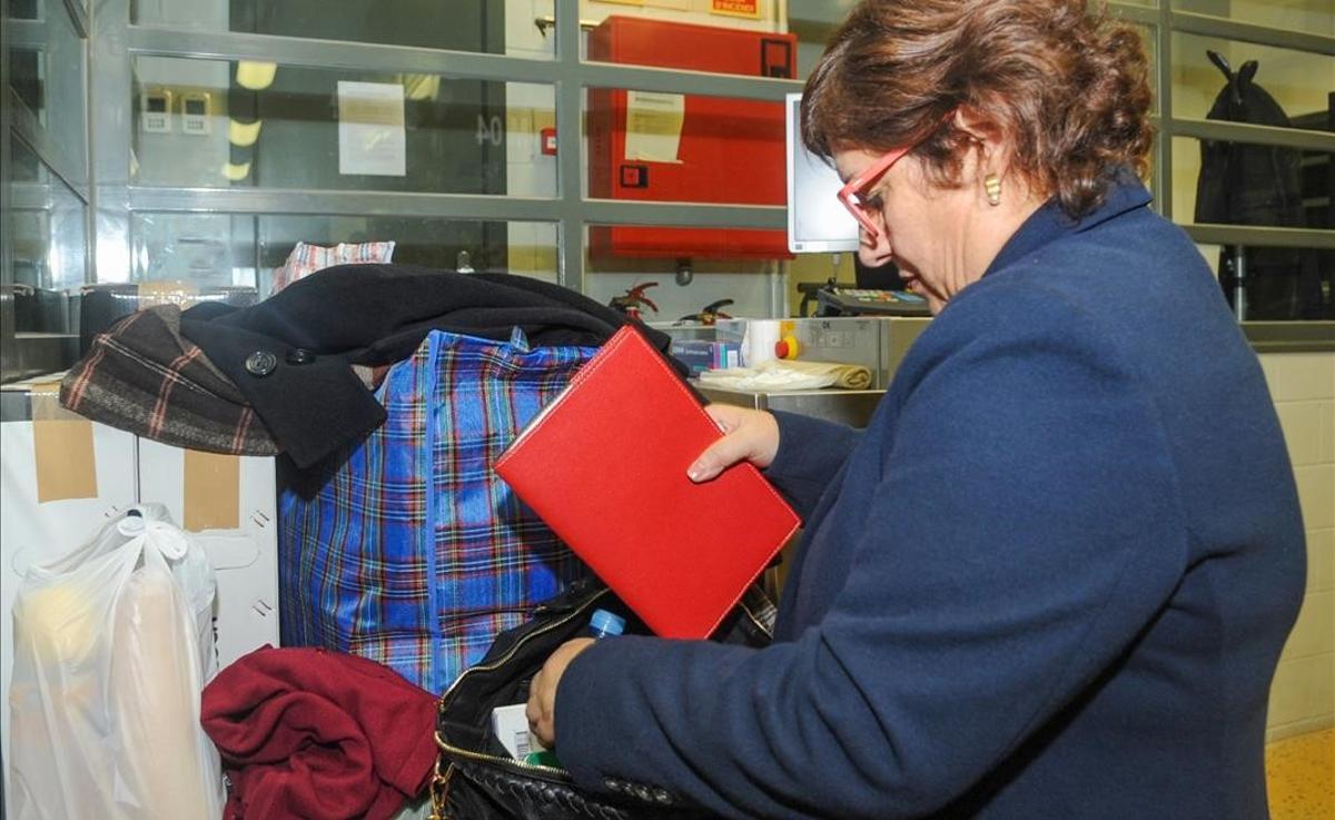 La ’exconsellera’ Dolors Bassa guarda objetos en una bolsa, minutos antes de su traslado a Madrid.