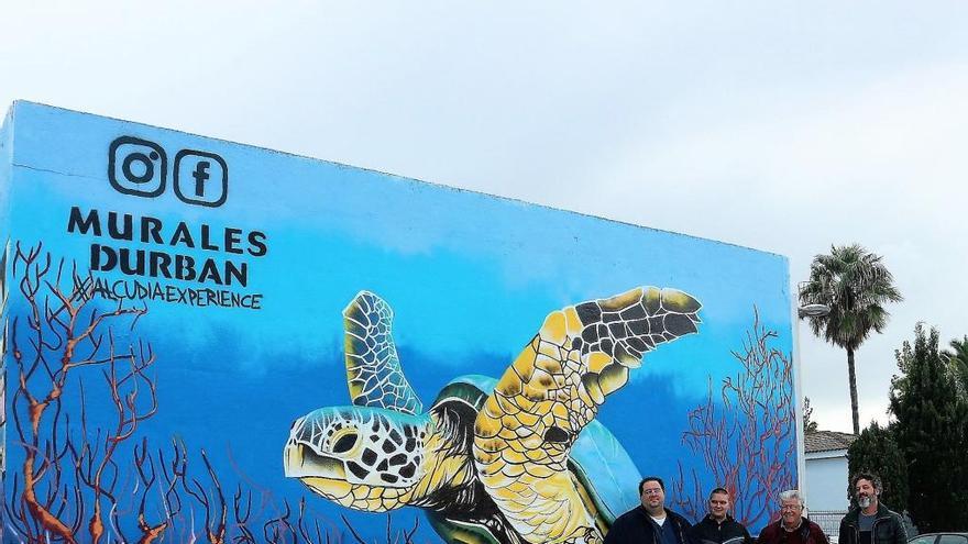 Las autoridades locales con Durban, autor de varios murales, ante uno de ellos