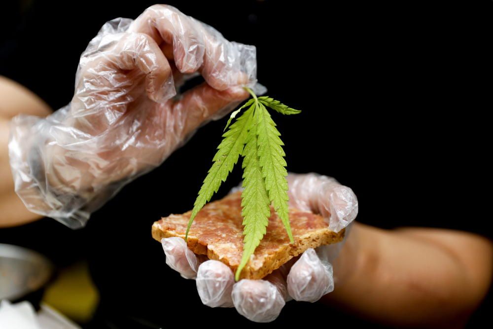 A chef prepares a pork sandwich with a marijuana ...