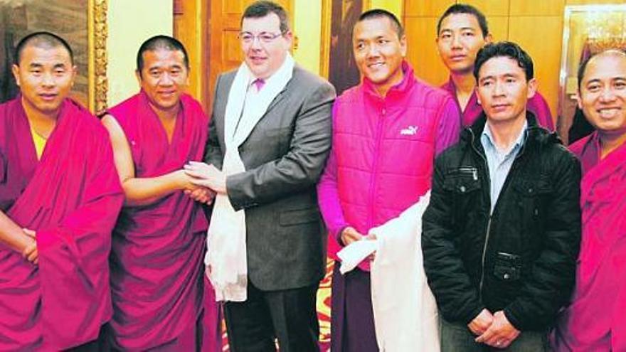 Santiago Martínez Argüelles, con su «kata» tibetano al cuello, posa con los cinco monjes tibetanos y uno de sus acompañantes en el salón de recepciones.