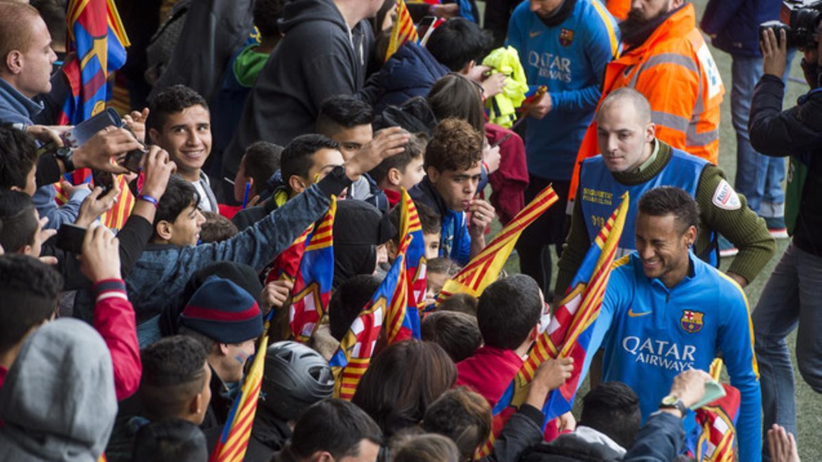 Neymar y Messi firman autógrafos durante el tradicional entrenamiento de puertas abiertas en el Mini Estadi.