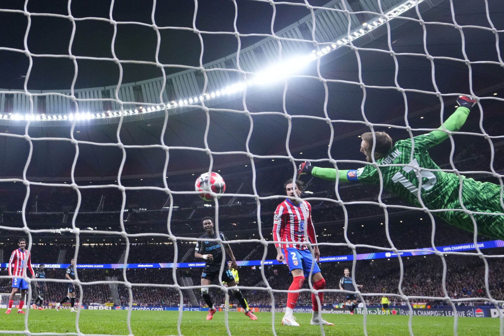 Atletico Madrid's goalkeeper Jan Oblak tries to stop a ball during a Champions League opening phase soccer match against Bayer 04 Leverkusen at the Riyadh Air Metropolitano stadium in Madrid, Spain, Tuesday, Jan. 21, 2025. (AP Photo/Manu Fernandez)