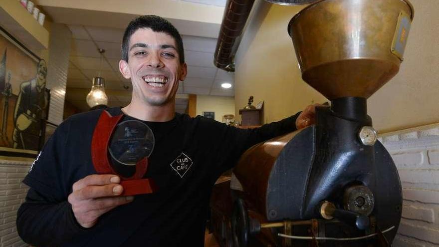 Gonzalo Rodríguez muestra su trofeo en la cafetería familiar en la que trabaja. // Gustavo Santos