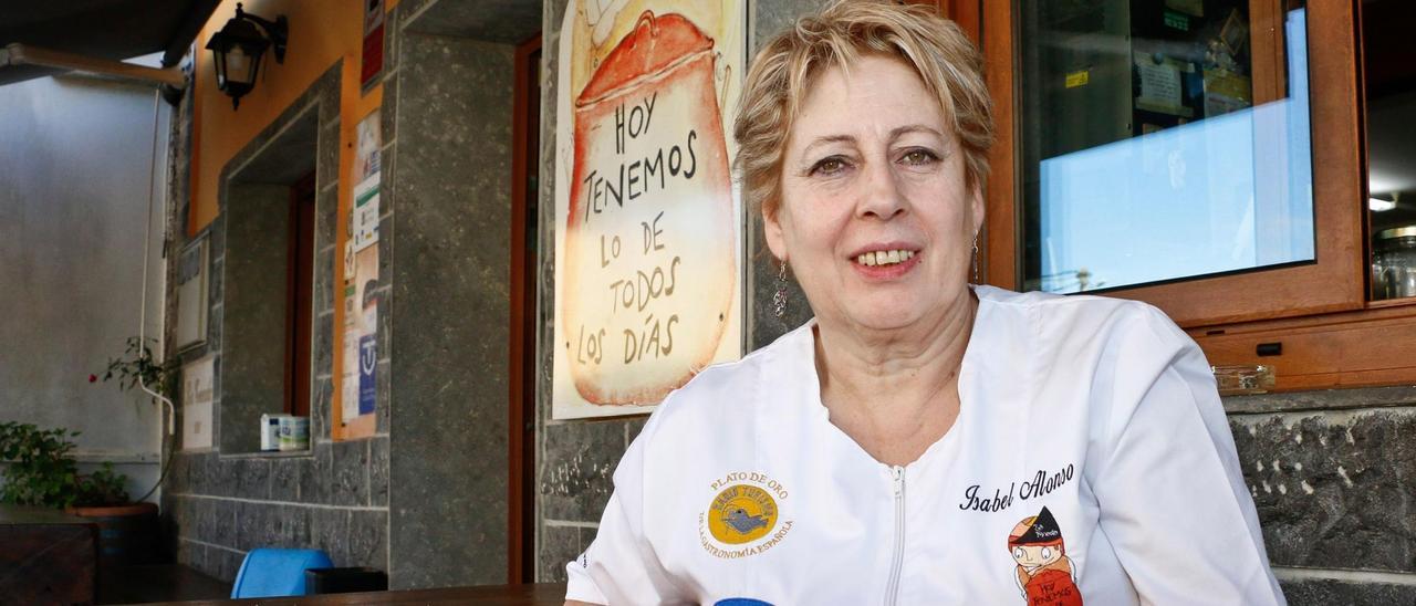 Isabel Alonso Moris, en la terraza de La Tenada, con el cartel que anuncia el menú.